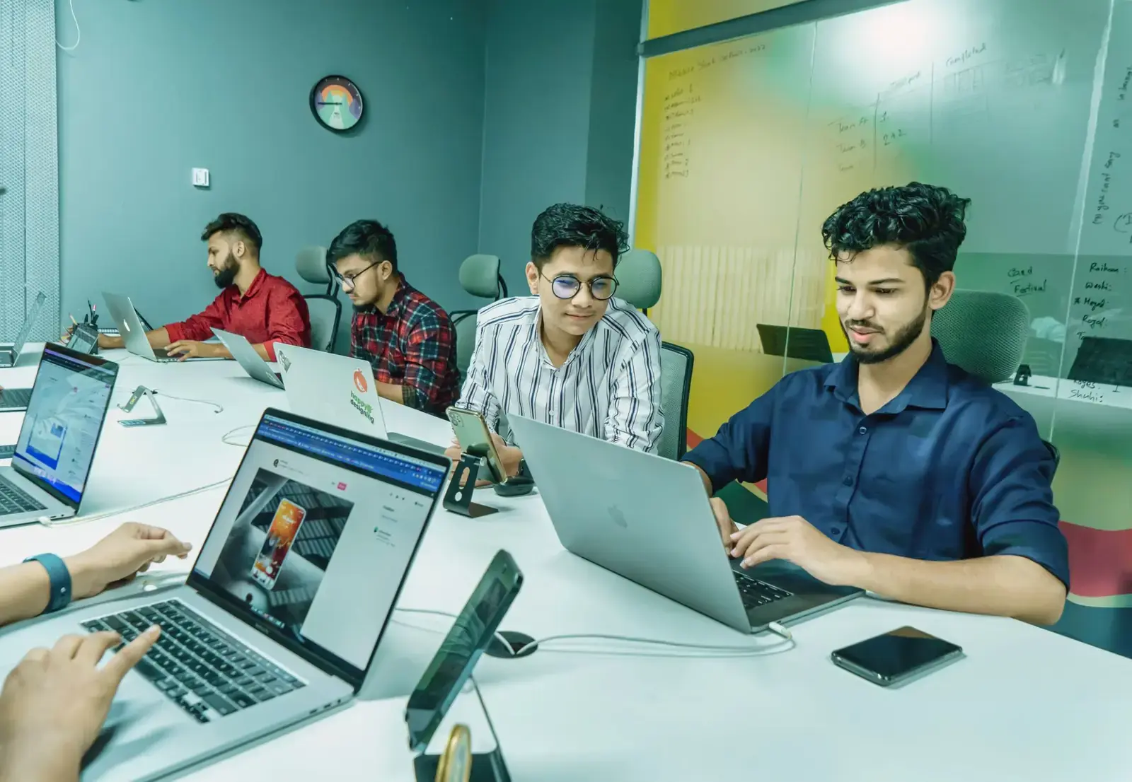 Founders working on laptops in a coworking space
